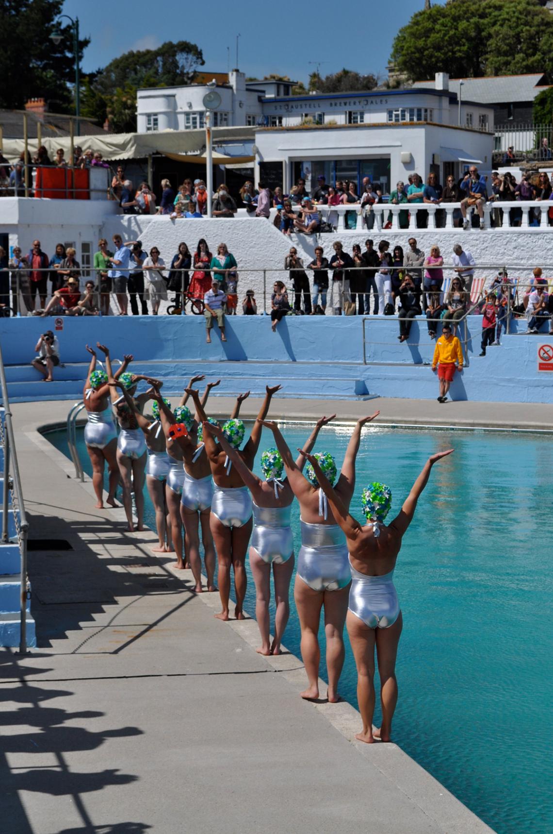 Synchronised swimmers prepare to dive at Art75